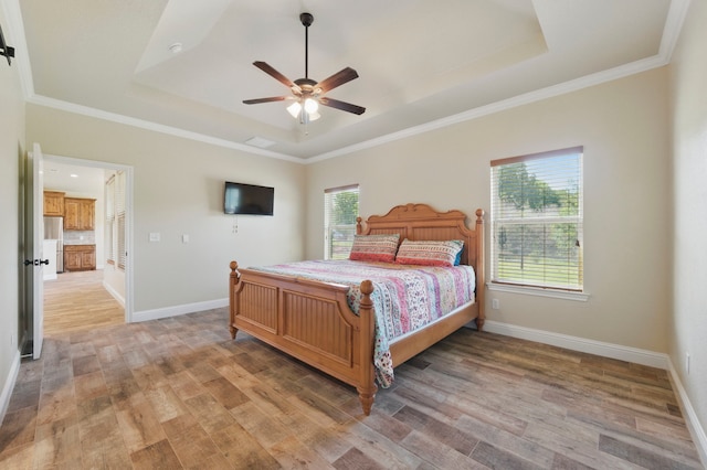 2304 Forest Hill Ln, Granbury, TX 76048 - bedroom with a raised ceiling, light wood-type flooring, baseboards, and ornamental molding
