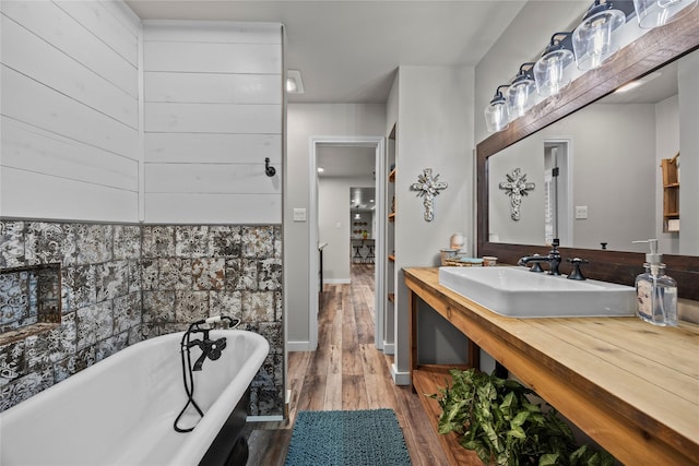 3280 Shady Grove Rd, Midlothian, TX 76065 - bathroom with wood finished floors, a freestanding tub, vanity, and baseboards
