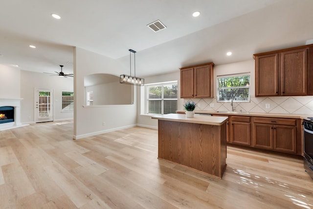479 Sausalito Dr, Rockwall, TX 75087 - kitchen with a kitchen island, a sink, decorative backsplash, ceiling fan, and recessed lighting