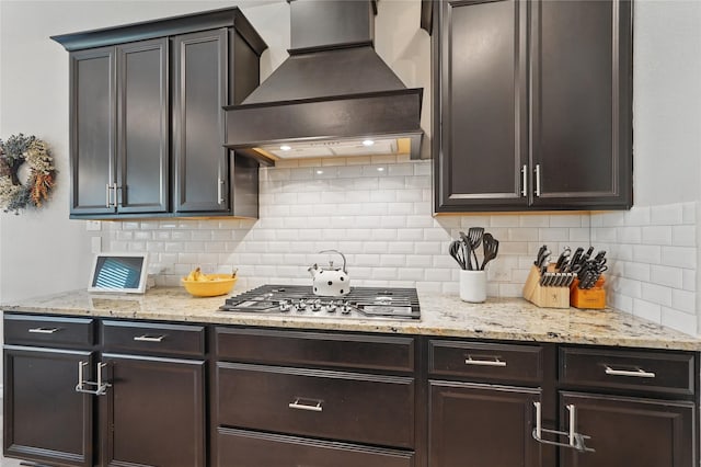 520 Shoreline Ridge Dr, Little Elm, TX 75068 - kitchen featuring custom exhaust hood, stainless steel gas stovetop, tasteful backsplash, and light stone counters