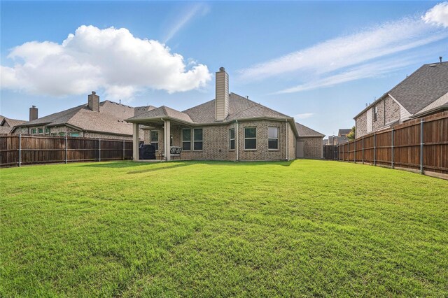 520 Shoreline Ridge Dr, Little Elm, TX 75068 - rear view of property featuring brick siding and a chimney