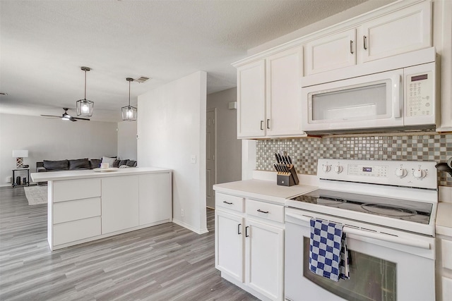 1308 Stetson Trl, Saginaw, TX 76131 - kitchen featuring white appliances, backsplash, open floor plan, and light wood-style flooring