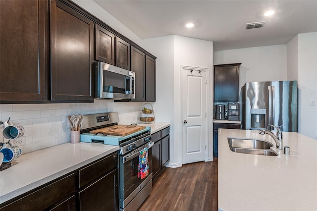 791 Evergreen St, Princeton, TX 75407 - kitchen with appliances with stainless steel finishes, a sink, dark wood-type flooring, dark brown cabinetry, and light countertops