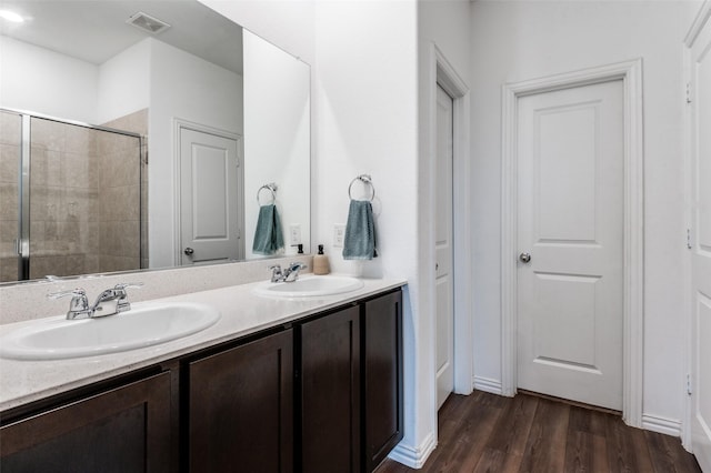 791 Evergreen St, Princeton, TX 75407 - full bathroom with tiled shower, wood finished floors, and double vanity