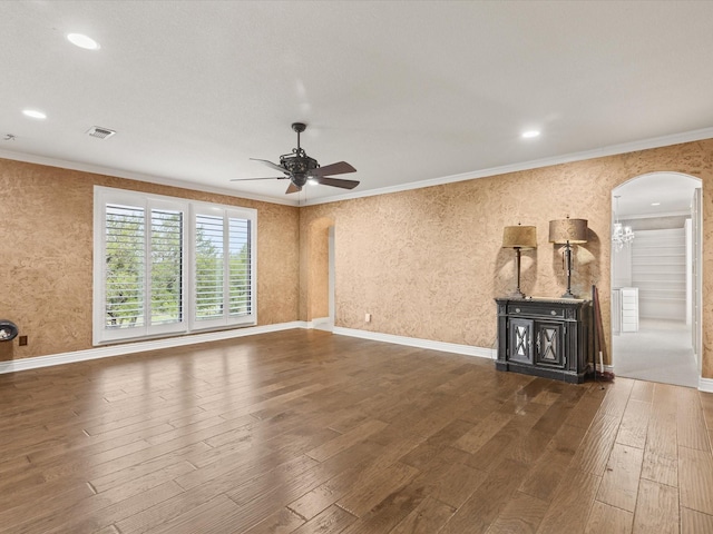 333 Forest Trl, Weatherford, TX 76085 - unfurnished living room with hardwood / wood-style flooring, a wood stove, ornamental molding, a ceiling fan, and arched walkways