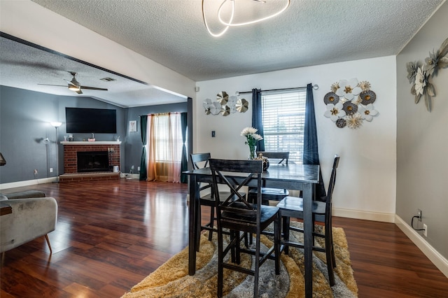 7419 Concordia Ln, Dallas, TX 75241 - dining room featuring a textured ceiling, plenty of natural light, wood finished floors, ceiling fan, and a fireplace