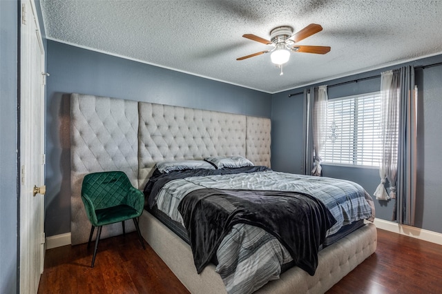 7419 Concordia Ln, Dallas, TX 75241 - bedroom featuring wood finished floors, a textured ceiling, baseboards, and a ceiling fan