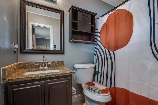 7419 Concordia Ln, Dallas, TX 75241 - full bathroom featuring vanity, toilet, and a textured ceiling