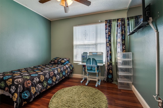 7419 Concordia Ln, Dallas, TX 75241 - bedroom with wood finished floors, a textured ceiling, baseboards, and a ceiling fan