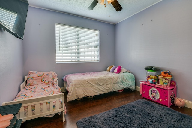 7419 Concordia Ln, Dallas, TX 75241 - bedroom featuring wood finished floors, a ceiling fan, and a textured ceiling