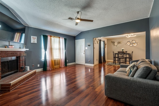 7419 Concordia Ln, Dallas, TX 75241 - living area with a ceiling fan, lofted ceiling, a fireplace, wood finished floors, and a textured ceiling