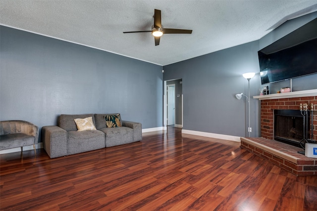 7419 Concordia Ln, Dallas, TX 75241 - living room featuring ceiling fan, wood finished floors, a textured ceiling, a fireplace, and baseboards