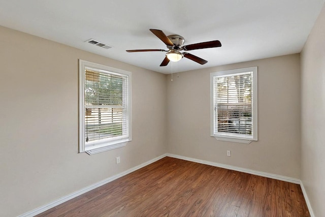 102 Mitscher Dr, Dallas, TX 75224 - empty room with baseboards, plenty of natural light, wood finished floors, and a ceiling fan