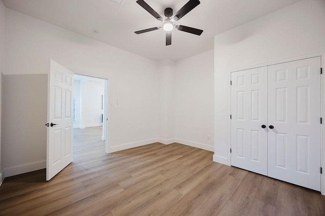 1410 Lee Ave, Fort Worth, TX 76164 - unfurnished bedroom featuring light wood finished floors, baseboards, a ceiling fan, and a closet