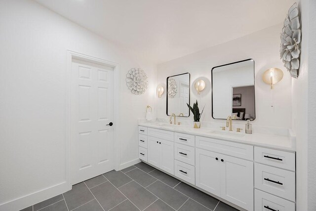 1410 Lee Ave, Fort Worth, TX 76164 - bathroom with double vanity, tile patterned flooring, and baseboards