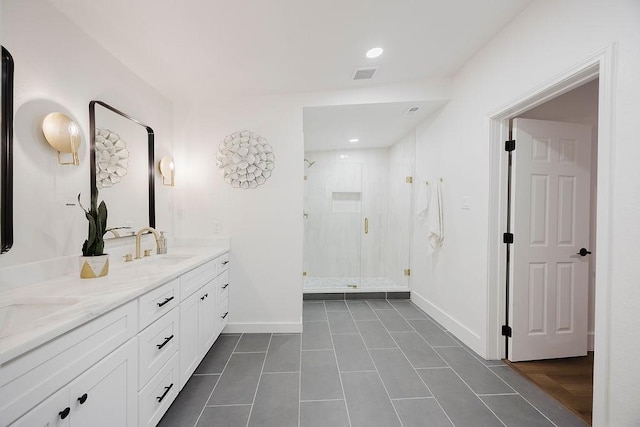 1410 Lee Ave, Fort Worth, TX 76164 - bathroom featuring double vanity, tile patterned floors, a stall shower, baseboards, and recessed lighting