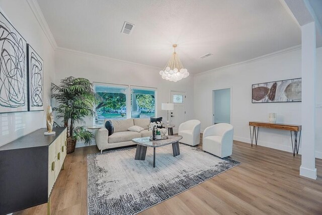 1410 Lee Ave, Fort Worth, TX 76164 - living area featuring light wood finished floors, a chandelier, and crown molding