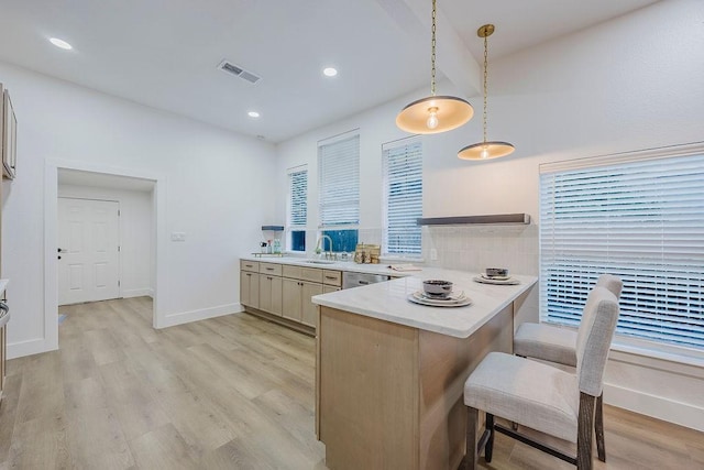 1410 Lee Ave, Fort Worth, TX 76164 - kitchen featuring light wood-style floors, a peninsula, a sink, light countertops, and beamed ceiling
