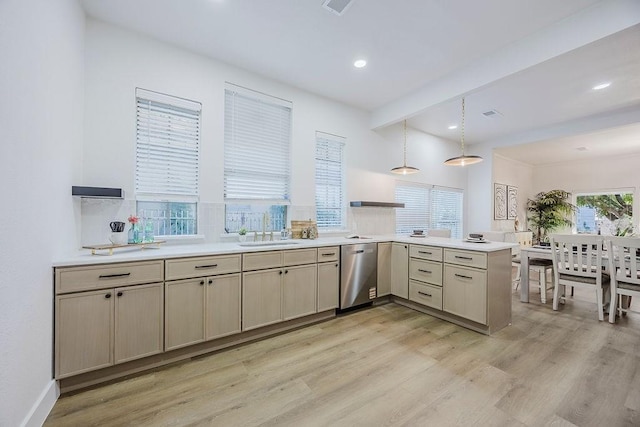 1410 Lee Ave, Fort Worth, TX 76164 - kitchen featuring stainless steel dishwasher, a peninsula, light wood finished floors, a sink, and light countertops