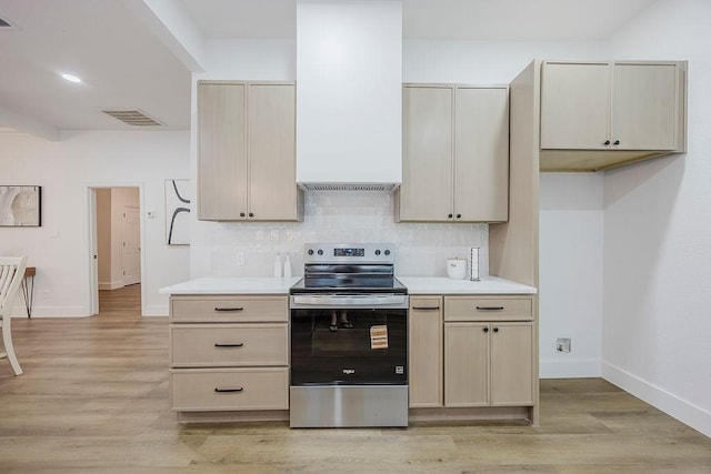 1410 Lee Ave, Fort Worth, TX 76164 - kitchen featuring stainless steel electric range oven, baseboards, light countertops, and light wood-style floors