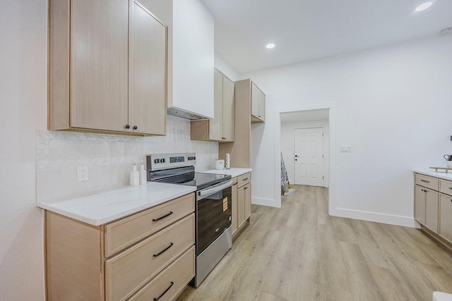 1410 Lee Ave, Fort Worth, TX 76164 - kitchen with electric stove, backsplash, light wood-style floors, light countertops, and baseboards