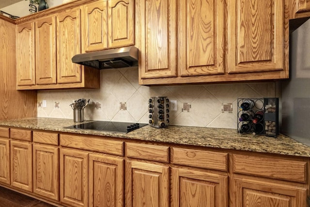 2324 Stone Creek Dr, Mckinney, TX 75072 - kitchen featuring under cabinet range hood, black electric cooktop, decorative backsplash, and stone counters