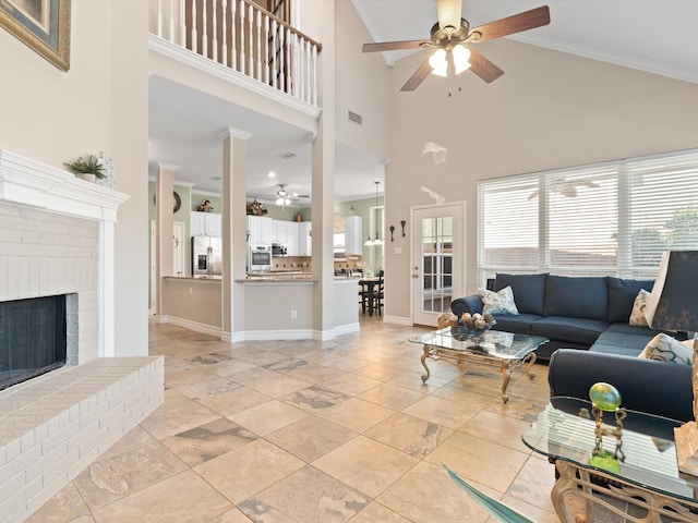 2448 Sky Harbor Dr, Plano, TX 75025 - living room with a ceiling fan, a high ceiling, a fireplace, baseboards, and crown molding