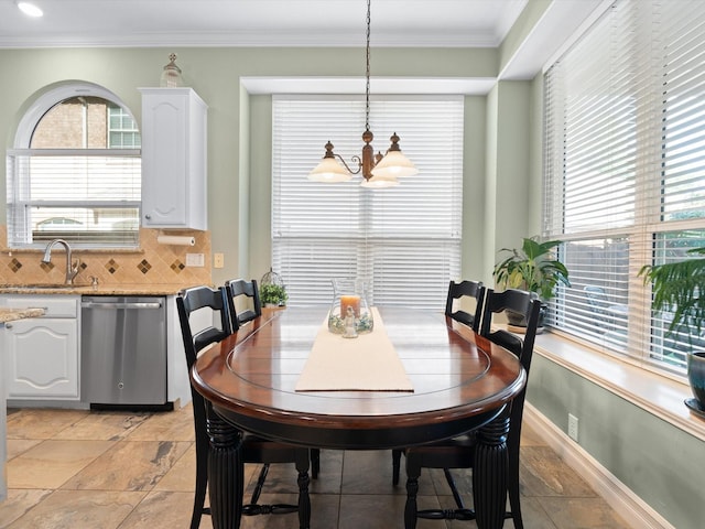 2448 Sky Harbor Dr, Plano, TX 75025 - dining room featuring a chandelier, crown molding, plenty of natural light, baseboards, and light stone finish flooring