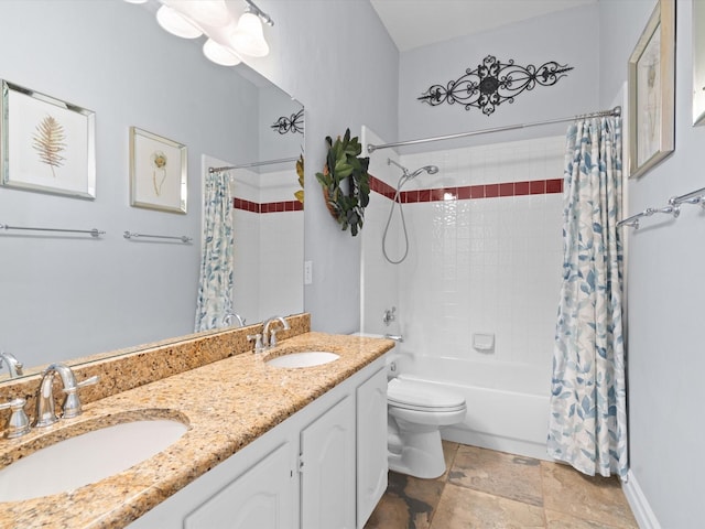 2448 Sky Harbor Dr, Plano, TX 75025 - full bathroom featuring shower / bath combo, toilet, double vanity, stone finish floors, and baseboards