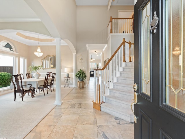 2448 Sky Harbor Dr, Plano, TX 75025 - foyer entrance featuring arched walkways, stairway, baseboards, a chandelier, and crown molding