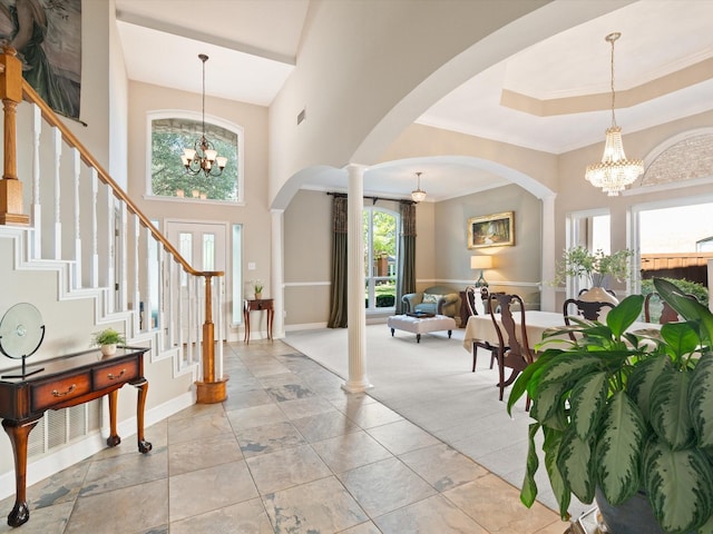 2448 Sky Harbor Dr, Plano, TX 75025 - entryway featuring a chandelier, plenty of natural light, arched walkways, stairs, and a high ceiling