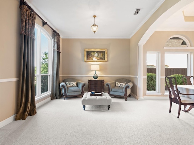 2448 Sky Harbor Dr, Plano, TX 75025 - sitting room featuring carpet flooring, crown molding, arched walkways, and baseboards