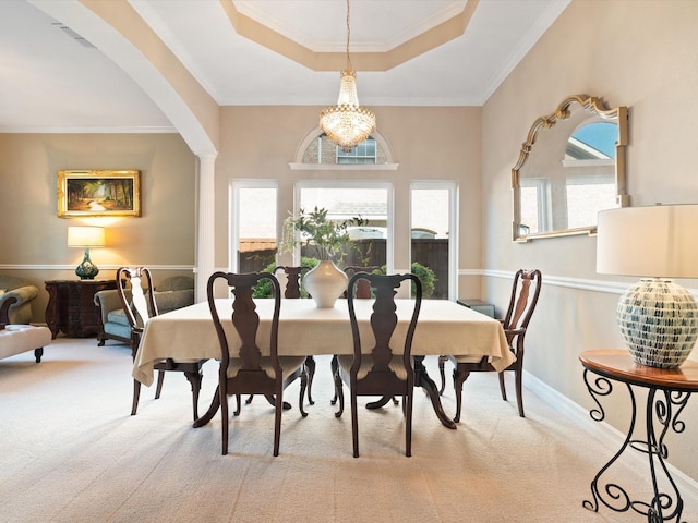 2448 Sky Harbor Dr, Plano, TX 75025 - dining area with carpet floors, a raised ceiling, arched walkways, healthy amount of natural light, and ornamental molding