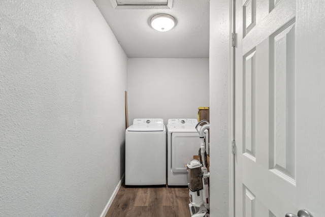 5225 Ira St N, Haltom City, TX 76117 - laundry room featuring washer and dryer, wood finished floors, baseboards, and a textured wall