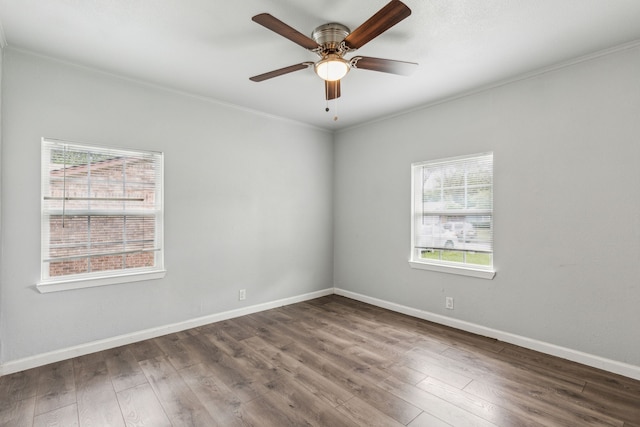 5225 Ira St N, Haltom City, TX 76117 - spare room featuring plenty of natural light, ornamental molding, wood finished floors, a ceiling fan, and baseboards