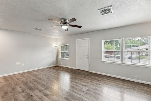 5225 Ira St N, Haltom City, TX 76117 - unfurnished room featuring ceiling fan, a textured ceiling, wood finished floors, and baseboards