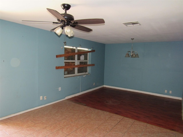 1221 Chestnut St, Waco, TX 76704 - empty room with a chandelier, ceiling fan, wood finished floors, and baseboards
