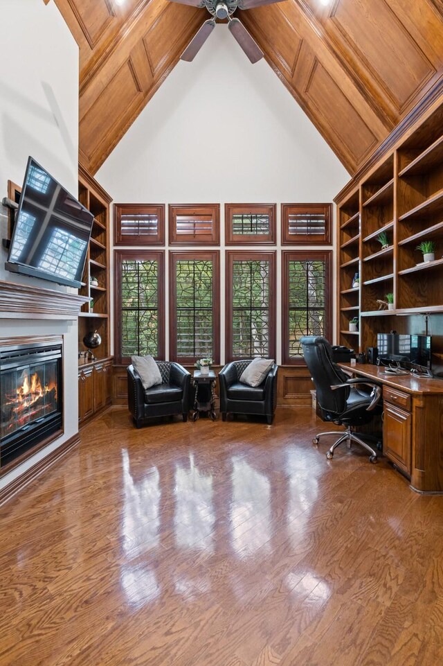 3206 Wintergreen Ter, Grapevine, TX 76051 - office area featuring high vaulted ceiling, a ceiling fan, wood finished floors, built in features, and a glass covered fireplace