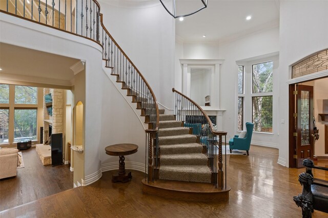 3206 Wintergreen Ter, Grapevine, TX 76051 - entryway featuring a high ceiling, a fireplace, healthy amount of natural light, stairs, and ornamental molding