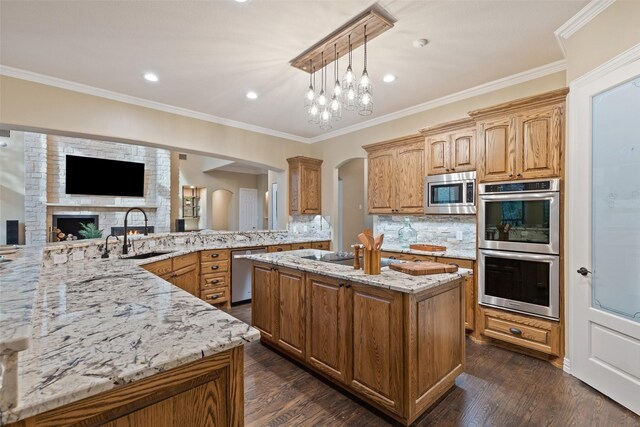 3206 Wintergreen Ter, Grapevine, TX 76051 - kitchen with a sink, stainless steel appliances, light stone counters, a center island with sink, and tasteful backsplash