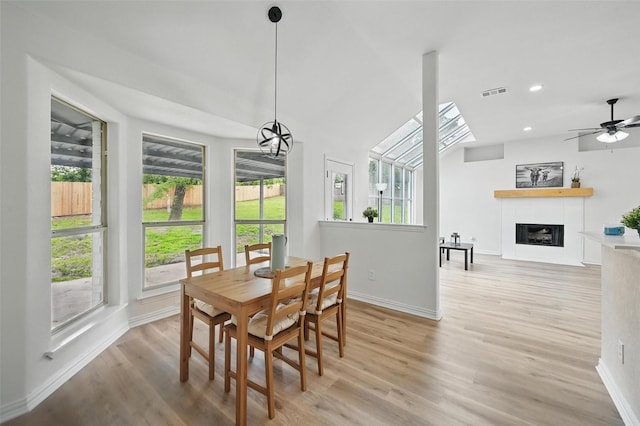 400 Baldwin Dr, Joshua, TX 76058 - dining space with baseboards, light wood finished floors, a tiled fireplace, a ceiling fan, and recessed lighting