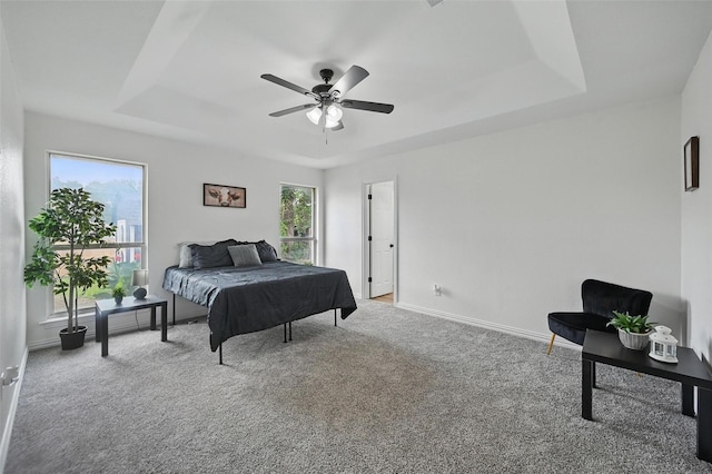 400 Baldwin Dr, Joshua, TX 76058 - carpeted bedroom with a tray ceiling, baseboards, and a ceiling fan