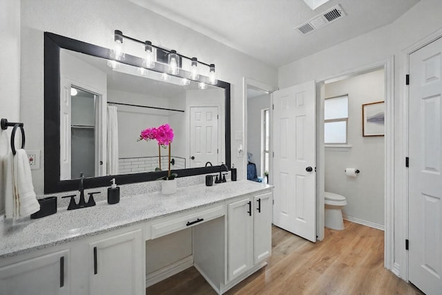 400 Baldwin Dr, Joshua, TX 76058 - bathroom with double vanity, toilet, and wood finished floors