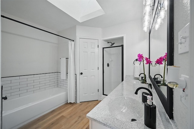 400 Baldwin Dr, Joshua, TX 76058 - bathroom featuring a skylight, a garden tub, vanity, wood finished floors, and a shower with curtain