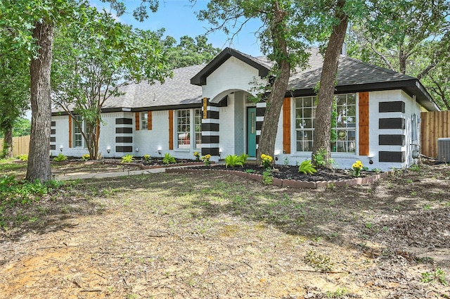 400 Baldwin Dr, Joshua, TX 76058 - view of front facade featuring a shingled roof, brick siding, and central AC unit
