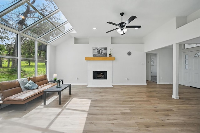 400 Baldwin Dr, Joshua, TX 76058 - living area with ceiling fan, a tile fireplace, baseboards, wood finished floors, and a towering ceiling