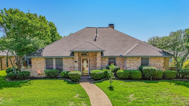 2810 Live Oak Dr, Rowlett, TX 75088 - view of front of property featuring brick siding, a front lawn, a chimney, and roof with shingles