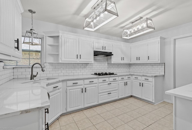 2810 Live Oak Dr, Rowlett, TX 75088 - kitchen with black gas cooktop, a sink, under cabinet range hood, open shelves, and white cabinetry