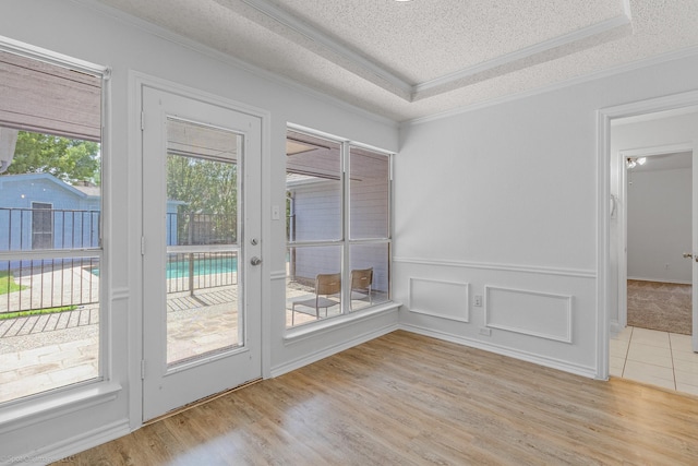 2810 Live Oak Dr, Rowlett, TX 75088 - empty room with a raised ceiling, ornamental molding, a textured ceiling, and wood finished floors