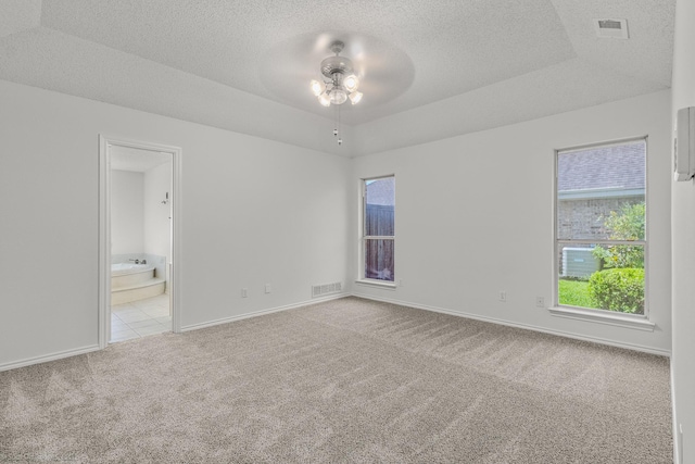 2810 Live Oak Dr, Rowlett, TX 75088 - carpeted spare room with a ceiling fan, a textured ceiling, baseboards, and a raised ceiling